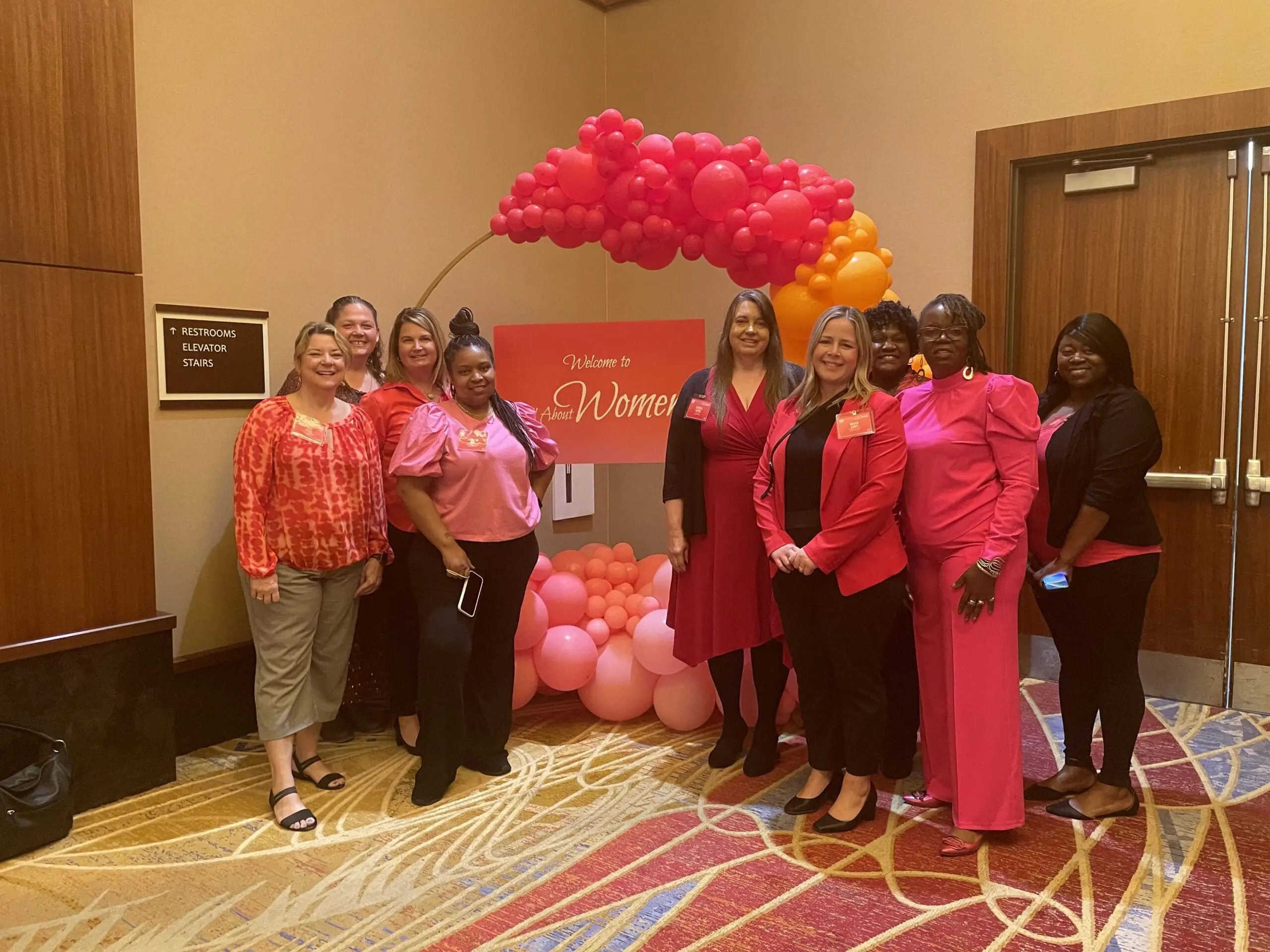Messer Construction Company female employees wearing pink and red at the All About Women Event