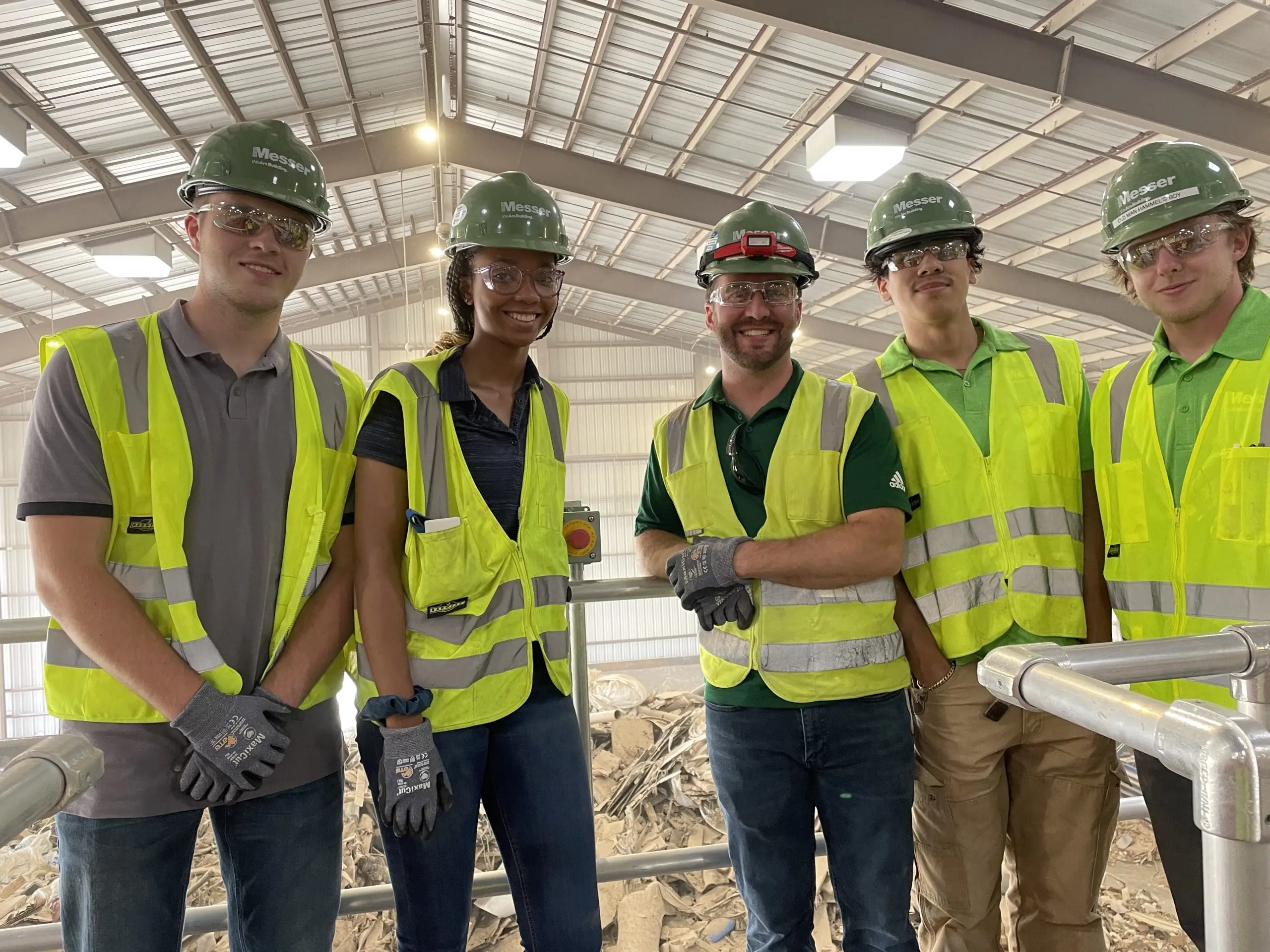 Group of Messer construction workers dressed in PPE posing for camera