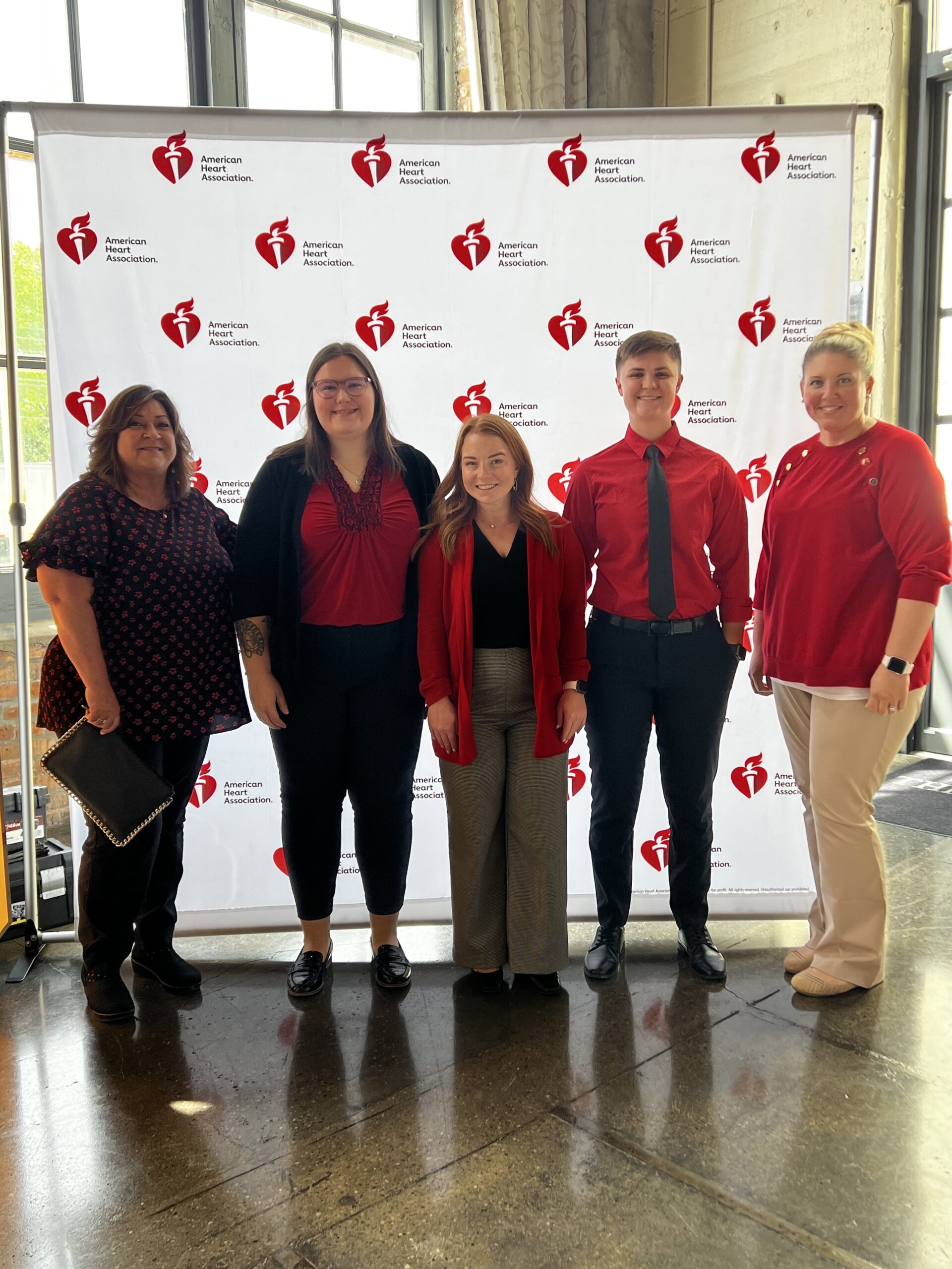 Messer Construction Company employees standing in front of American heart association event signage