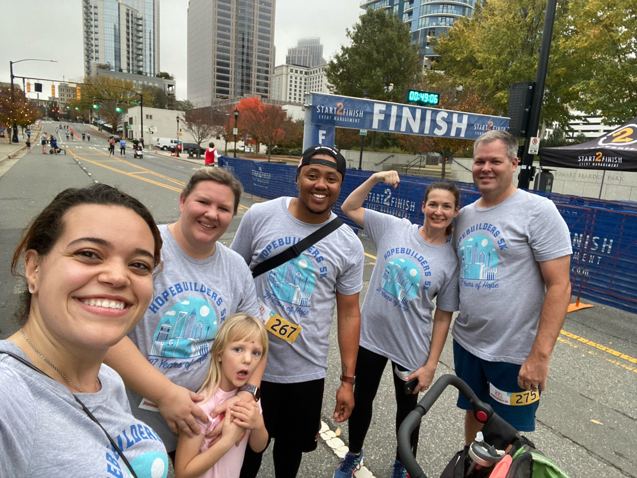 Messer Construction Company employees standing by the finish line posing for the camera