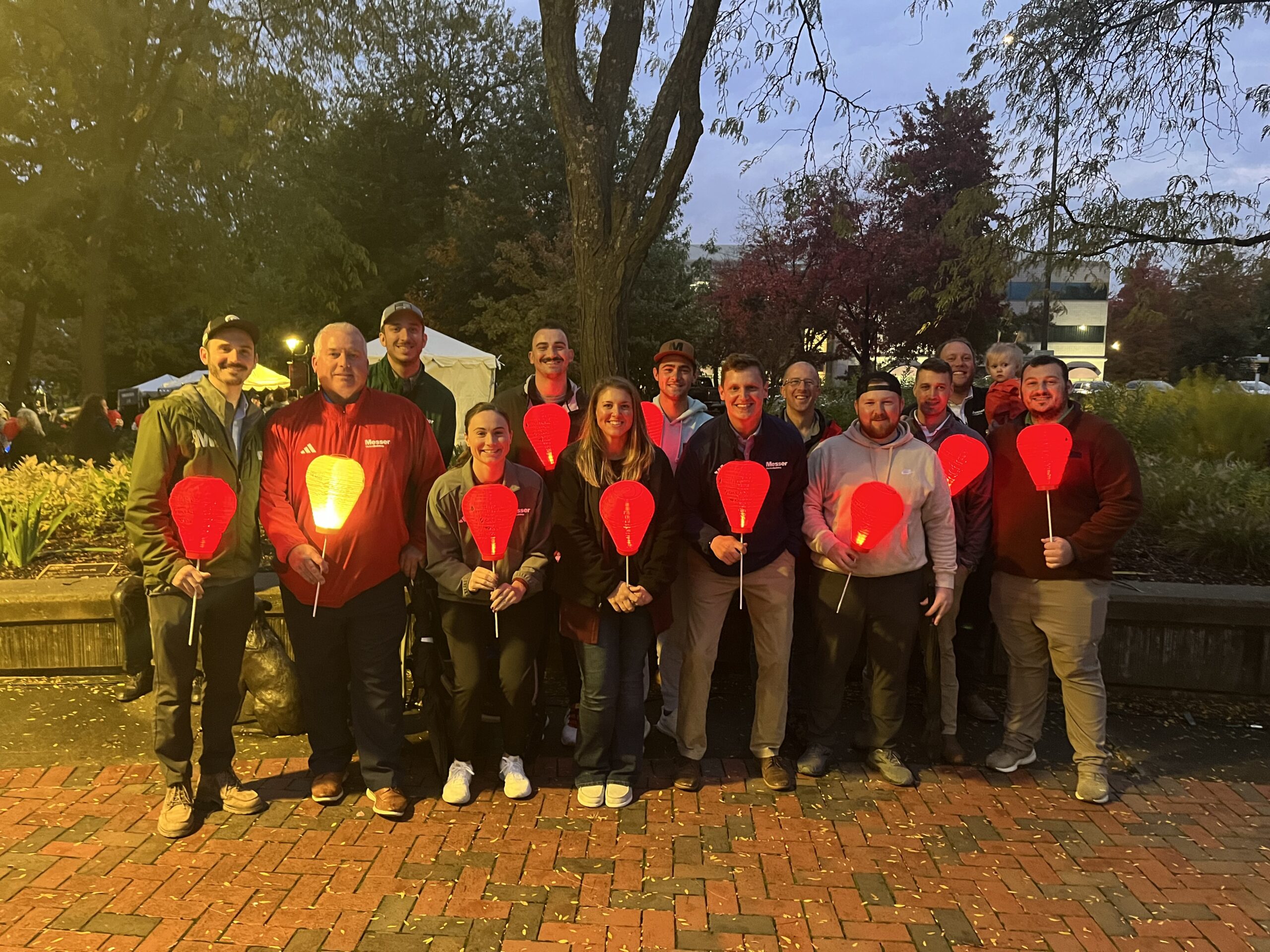 Messer Construction Company employees in Dayton holding lanterns at night for Light the Night event