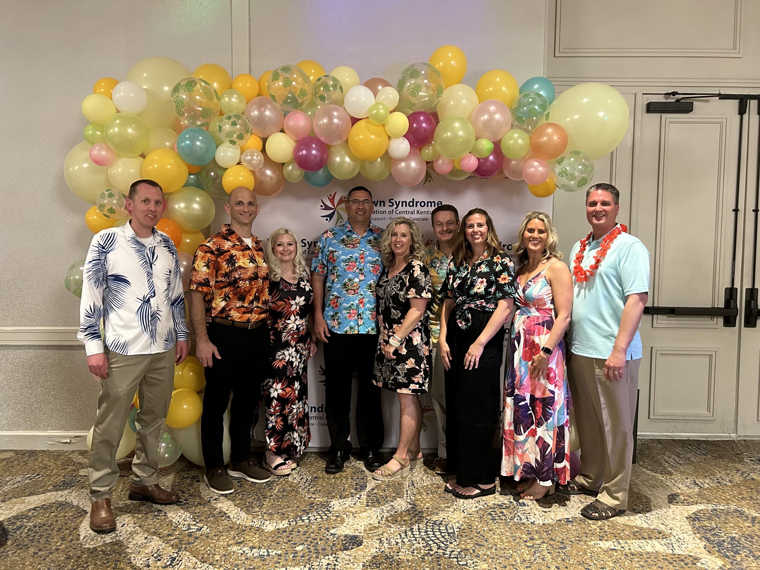 Messer Construction Company employees wearing tropical outfits posing for the camera at a Gala