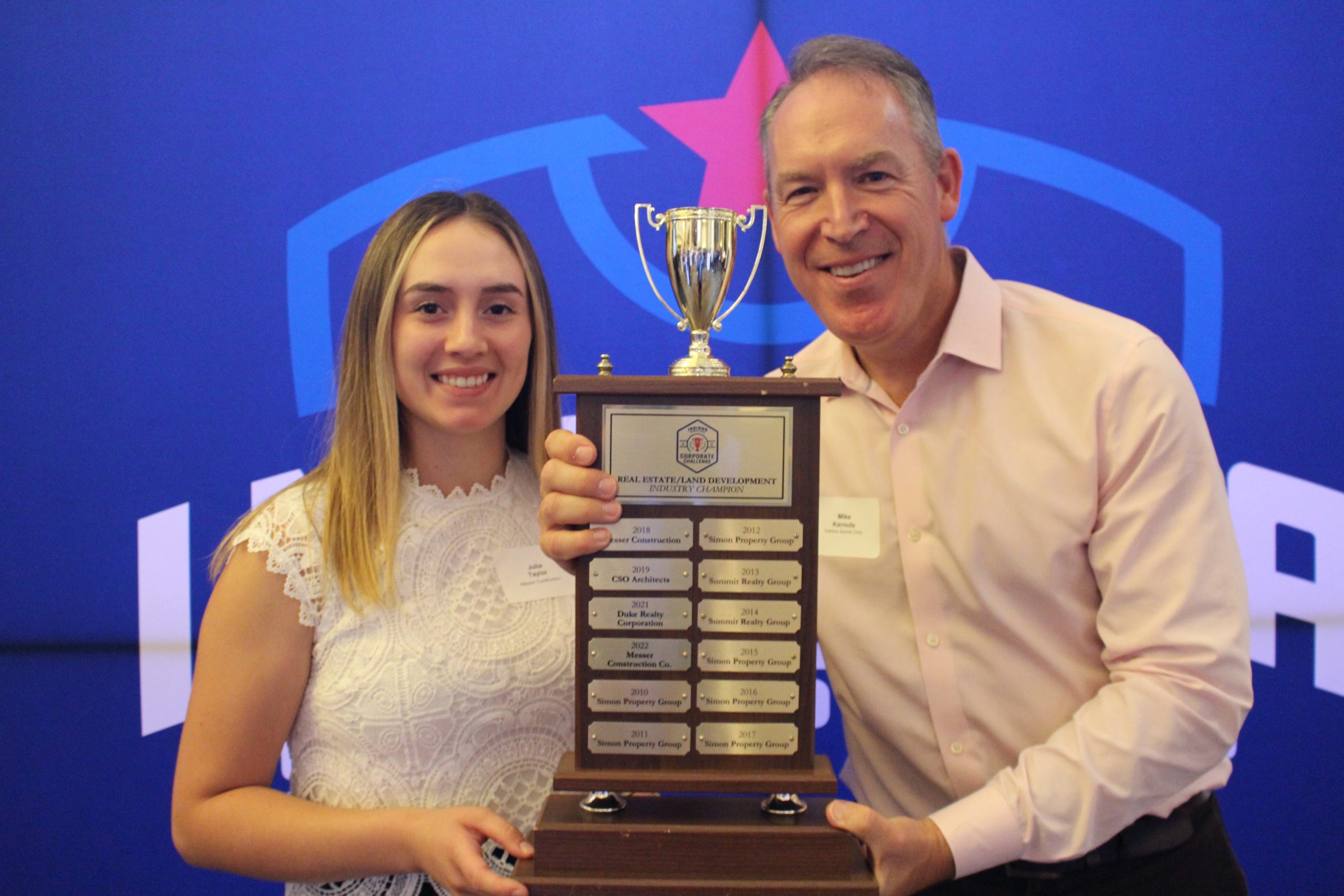 Two people holding award