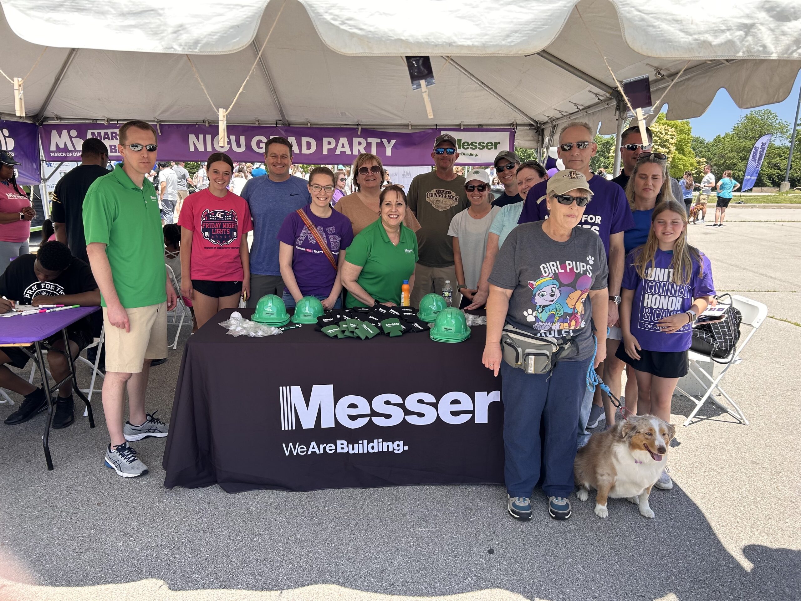 Messer Construction Company employees posing outdoors at Messer booth
