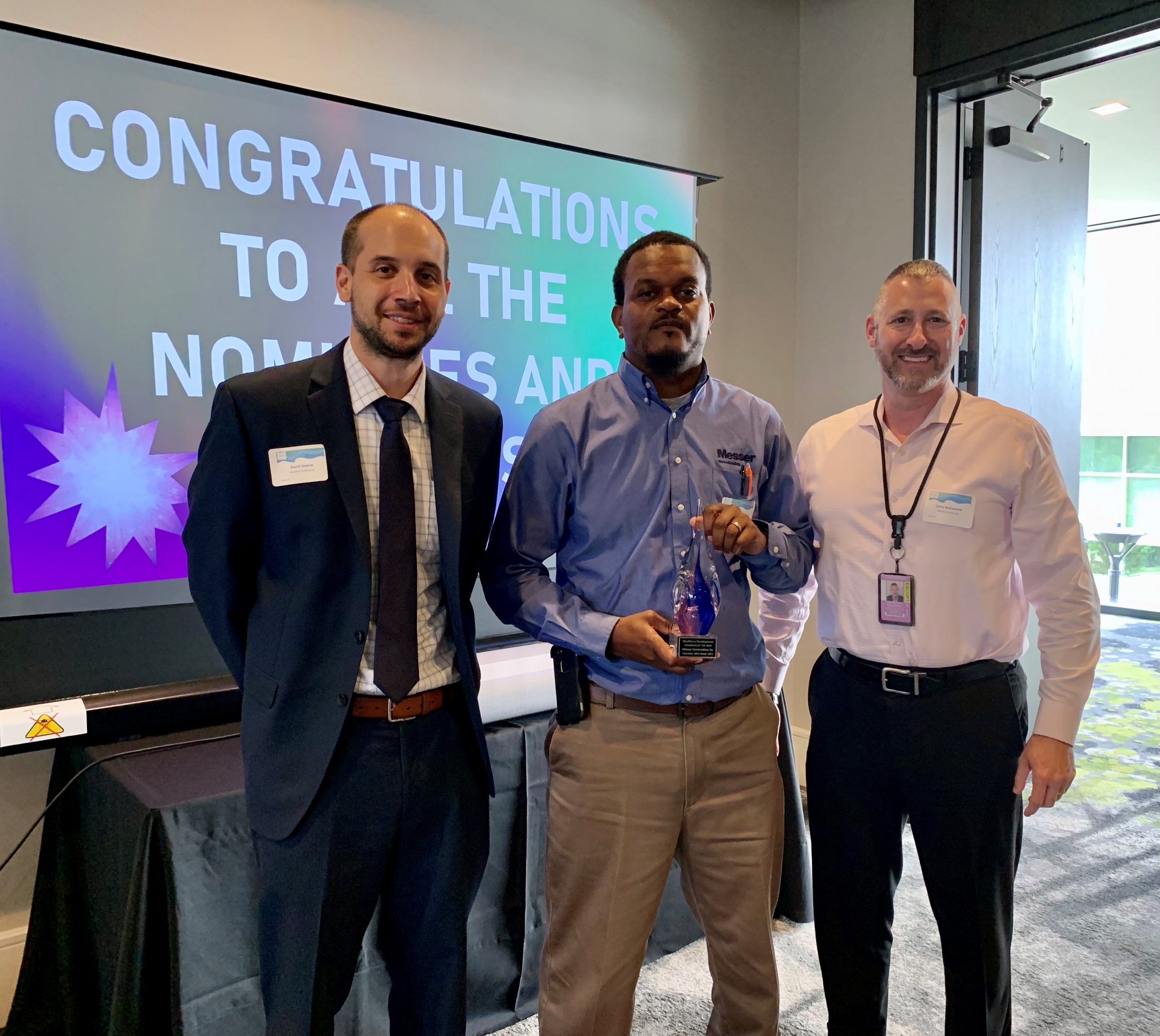 Men holding award