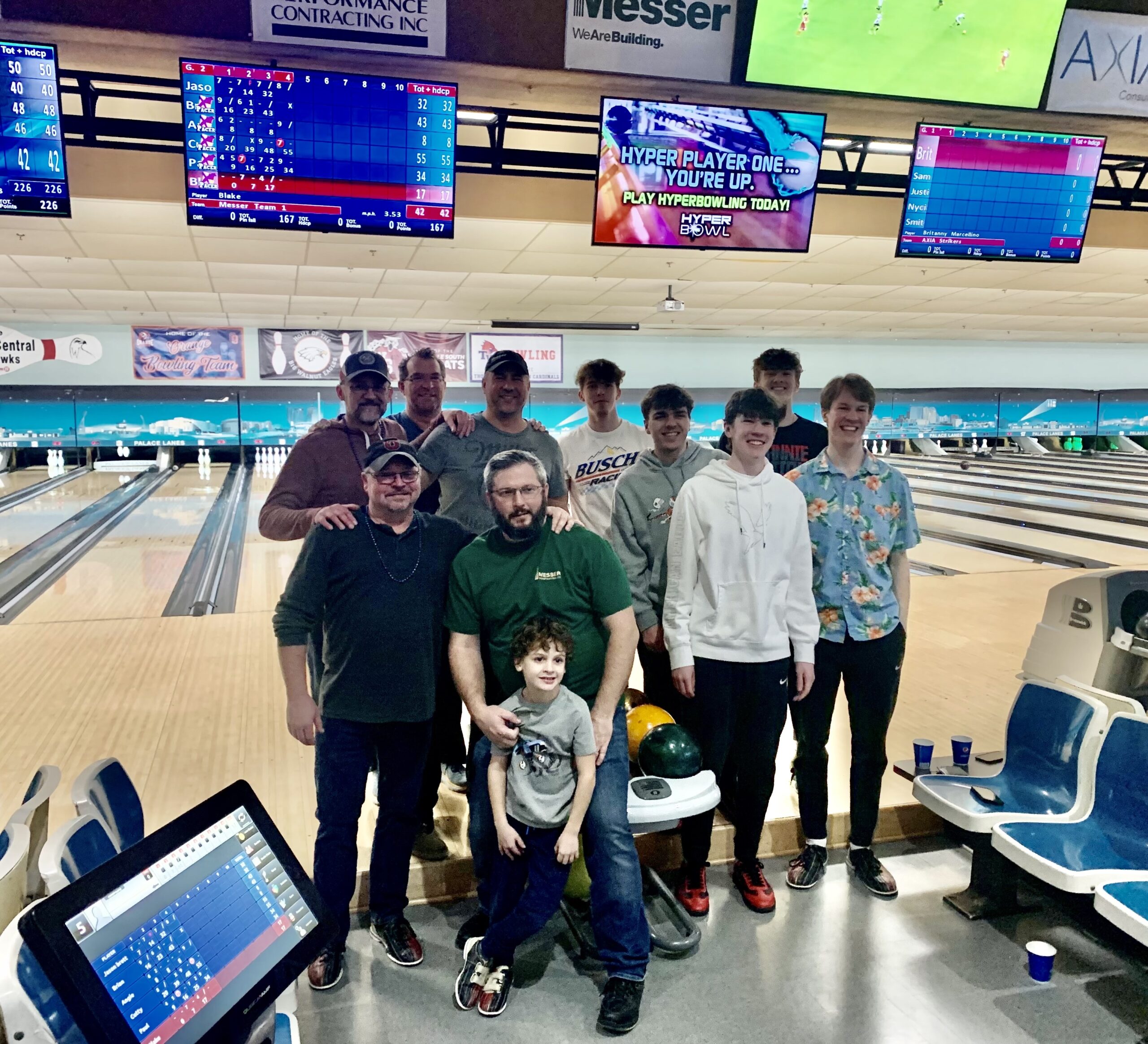 Messer Construction Company employees in bowling alley standing in front of the lanes