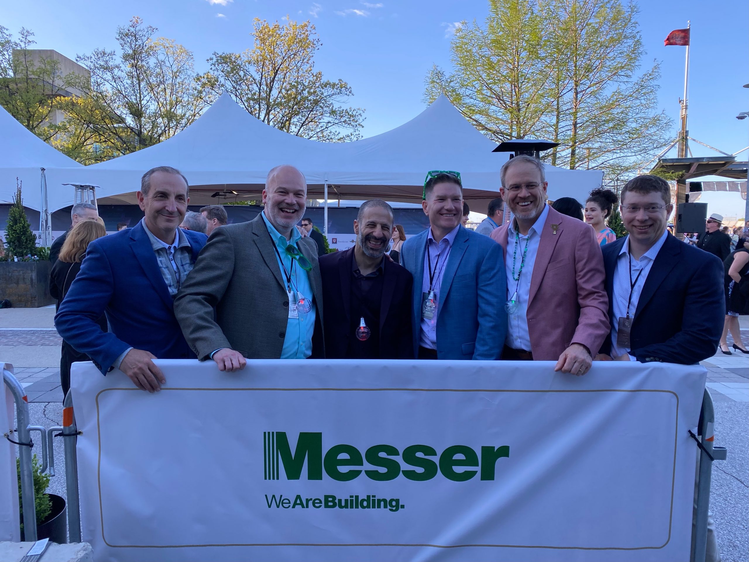 Messer Construction Co employees holding Messer banner