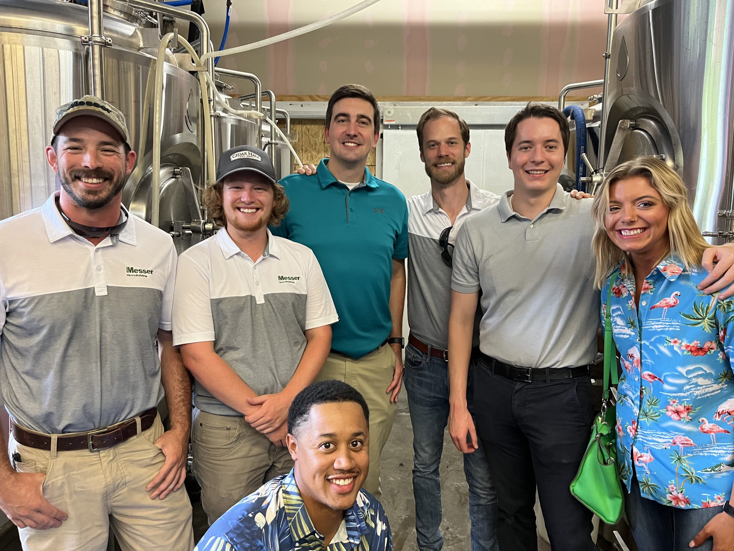 Group of people standing in a brewery