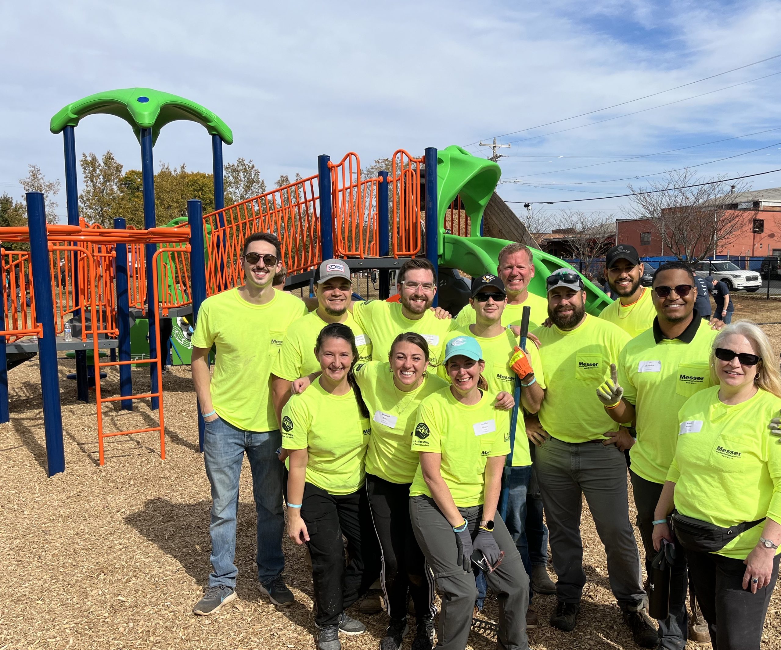Group of volunteers standing outside on a playground