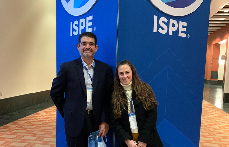 Two people standing in front of ISPE CaSA sign