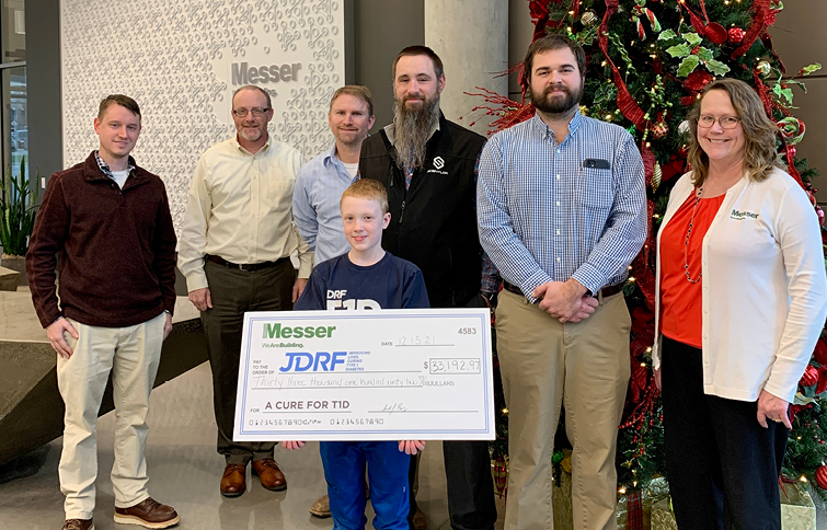 People holding large check