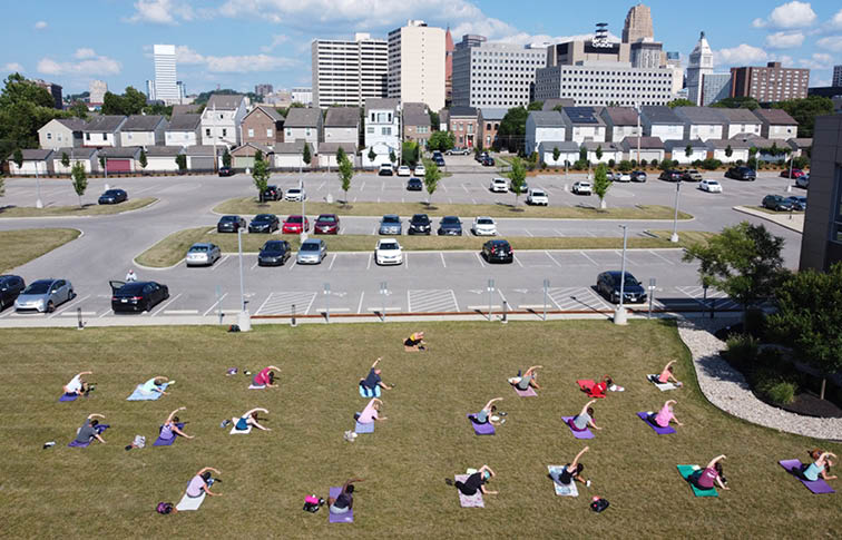 Aerial photo of people doing yoga outdoors in front of Messer Construction Co. corporate office