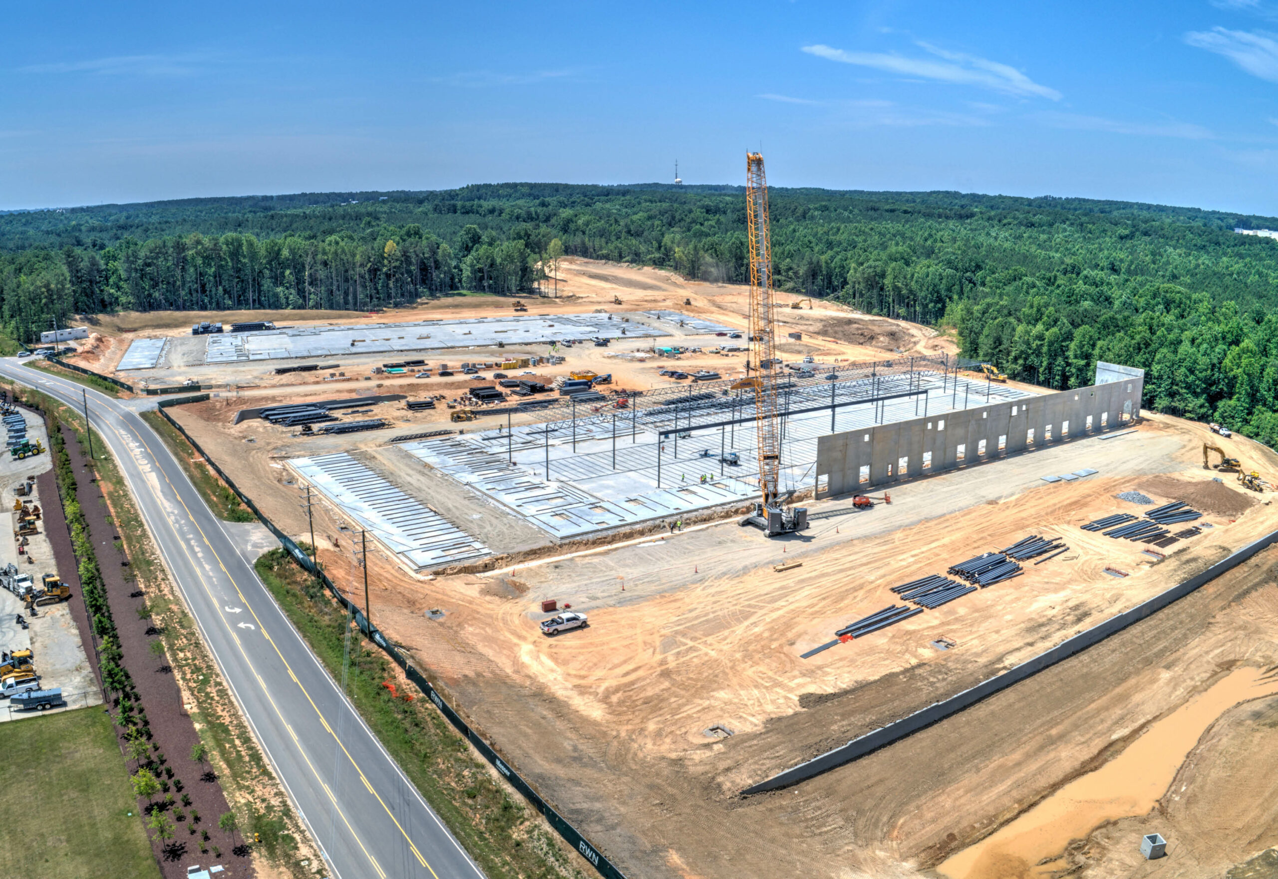 aerial photo of two under-construction industrial buildings